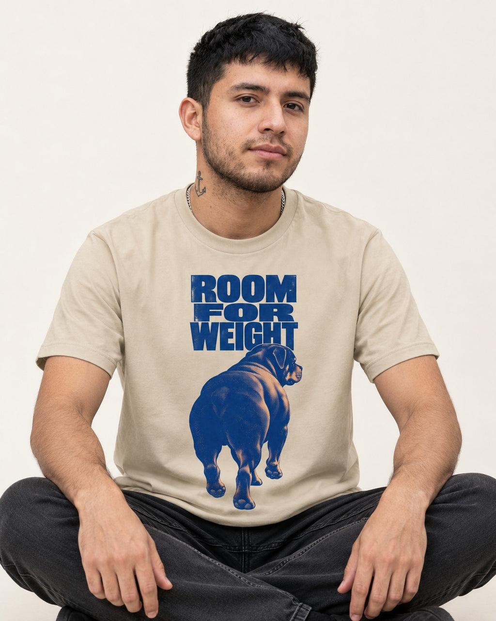 Room for Weight Rottweiler T-Shirt in Sand, worn by a seated model