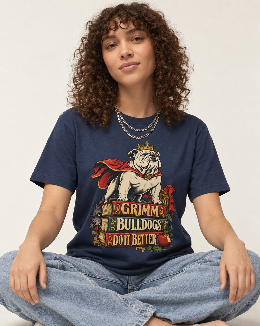 English Bulldog Grimm Bulldogs Do It Better Storybook Graphic T-Shirt in Navy, worn by a seated model