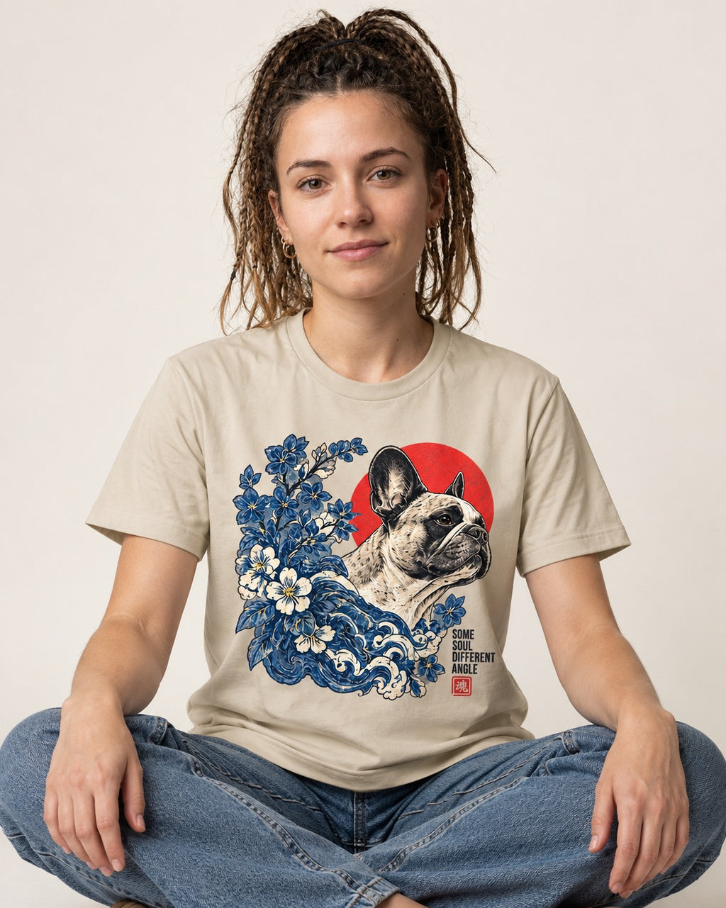 Some Soul Different Angle Frenchie T-Shirt in Sand, worn by a seated model