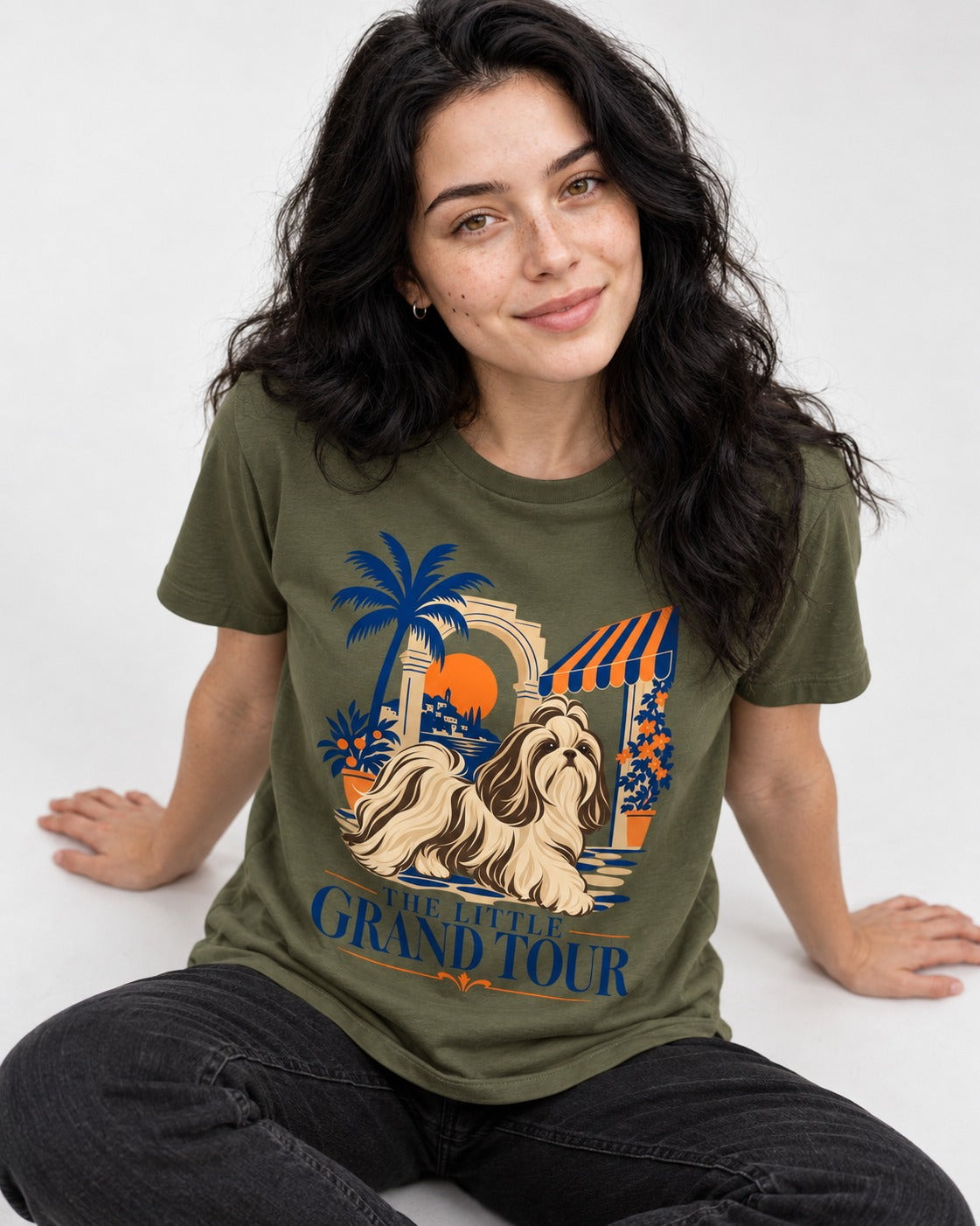 Shih Tzu The Little Grand Tour Mediterranean Courtyard Graphic T-Shirt in Heather Military Green, worn by a seated model