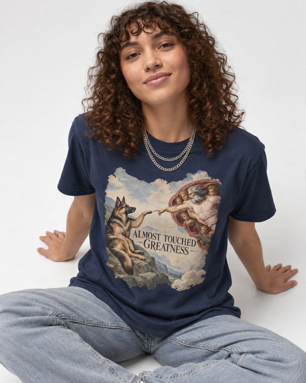 German Shepherd Dog Almost Touched Greatness Creation Parody T-Shirt in Navy, worn by a seated model