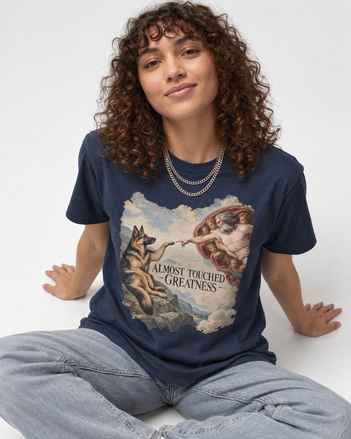 German Shepherd Dog Almost Touched Greatness Creation Parody T-Shirt in Navy, worn by a seated model