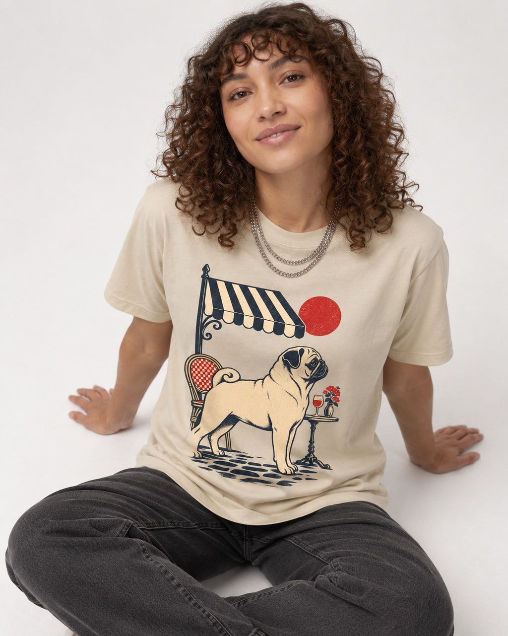 Pug Joie De Vivre T-Shirt in Sand, worn by a seated model
