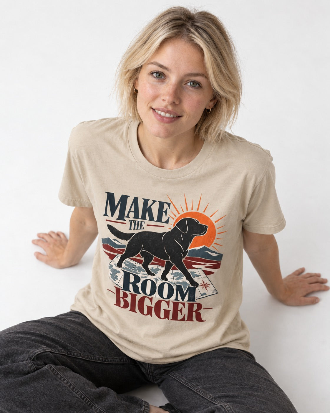 Make the Room Bigger Labrador Retriever T-Shirt in Sand, worn by a seated model