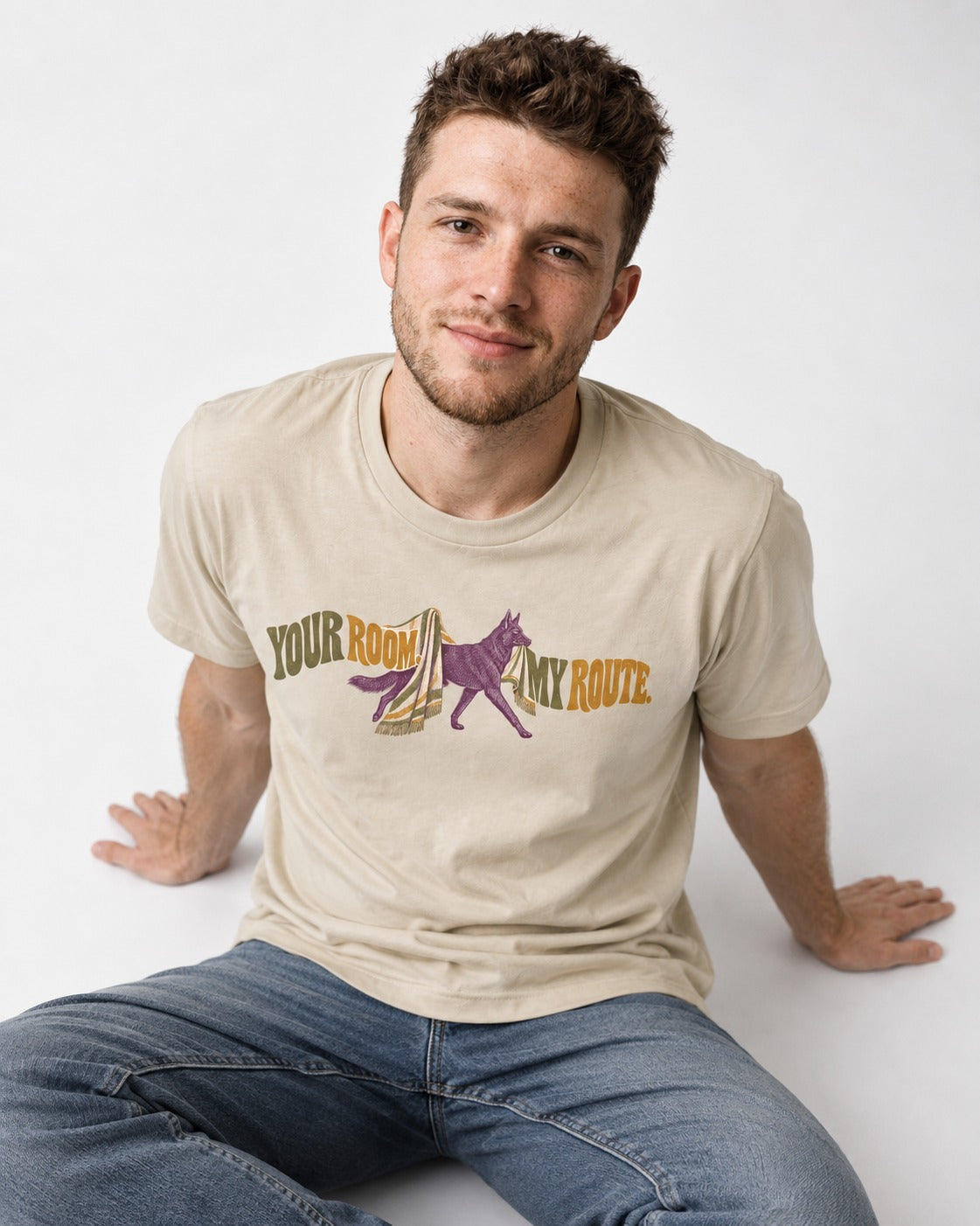 Your Room My Route German Shepherd Dog T-Shirt in Sand, worn by a seated model