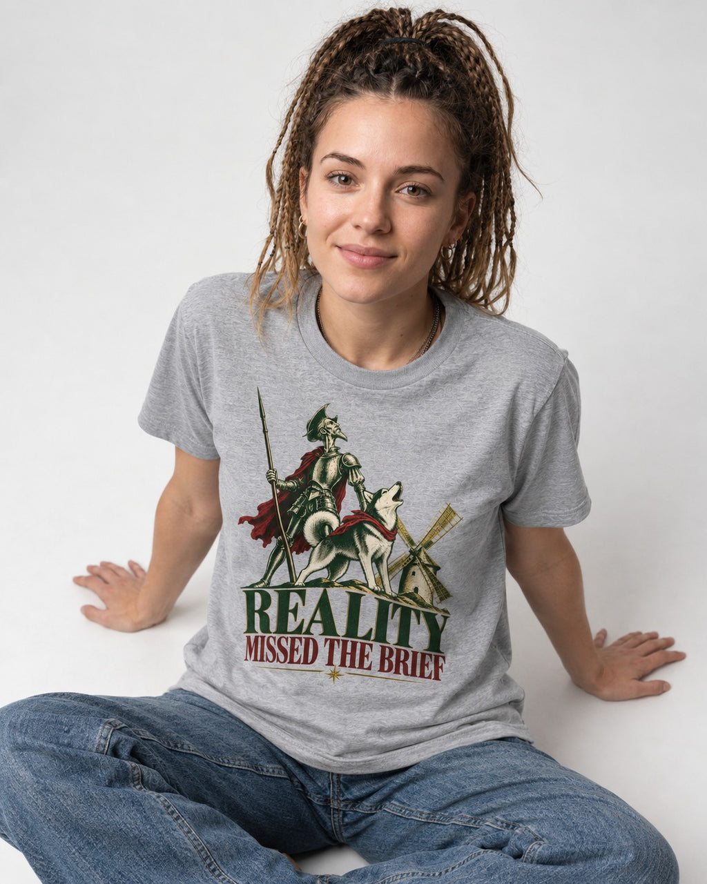Reality Missed the Husky Brief T-Shirt in Sport Grey, worn by a seated model