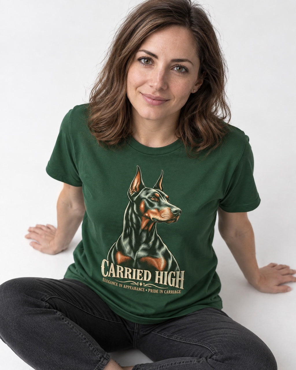 Doberman Carried High Portrait Graphic T-Shirt in Forest Green, worn by a seated model