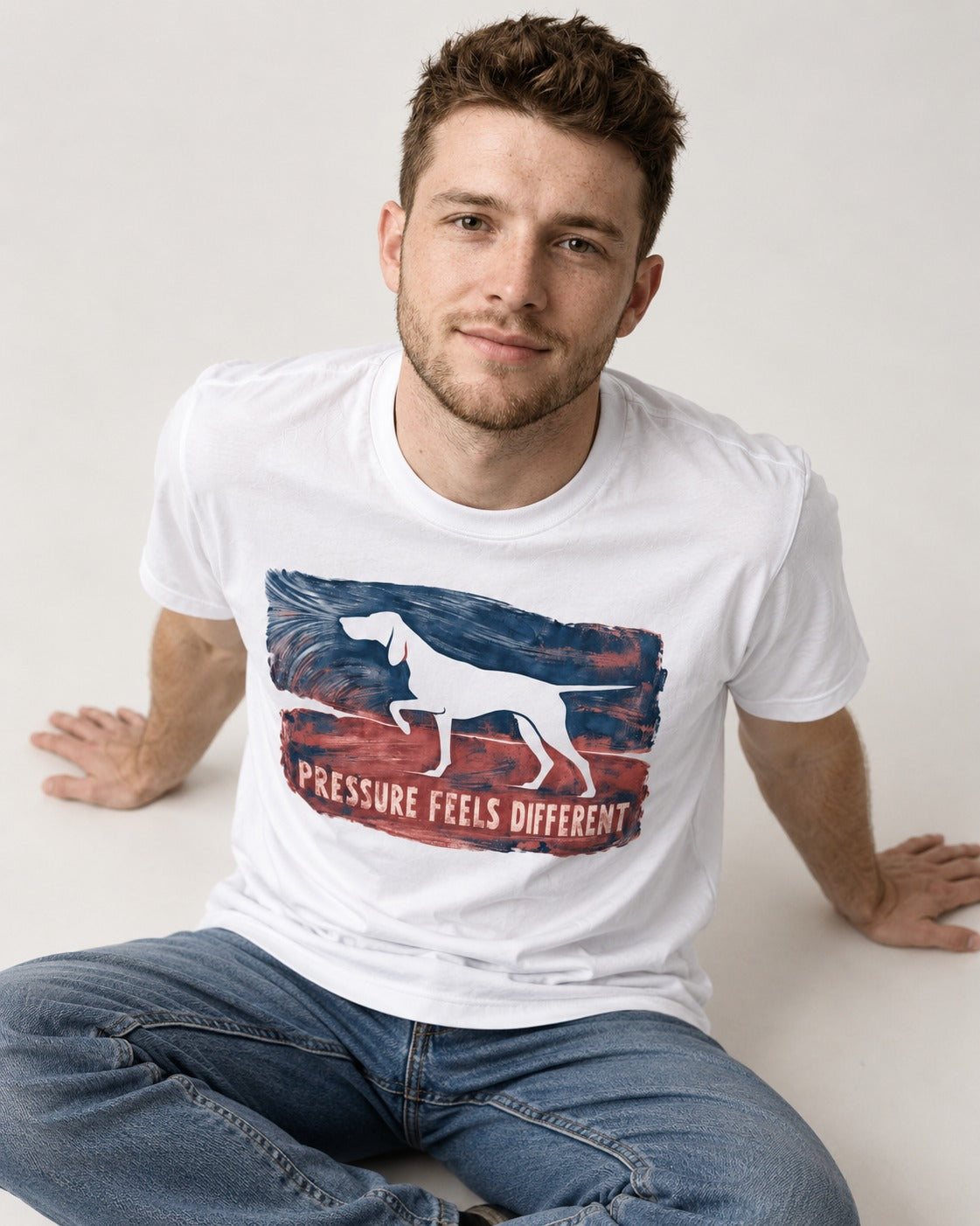 German Shorthaired Pointer Pressure Feels Different Monotype Graphic T-Shirt in White, worn by a seated model