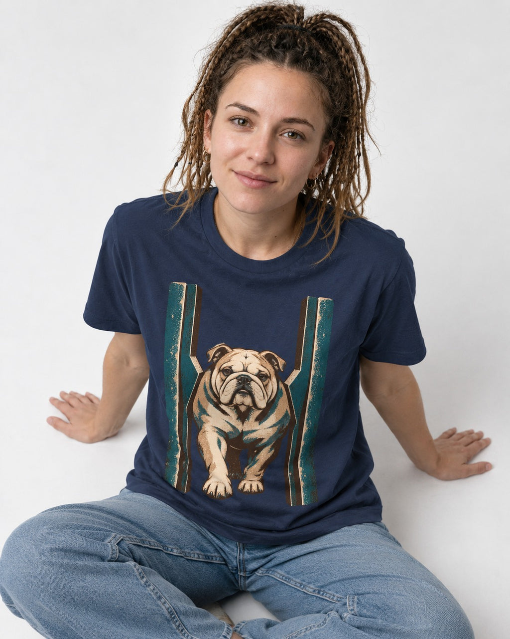 English Bulldog Walking Through Teal Gate Graphic T-Shirt in Navy, worn by a seated model
