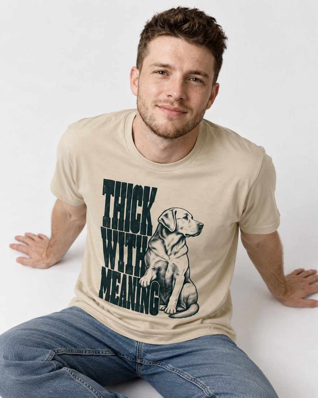 Thick with Meaning Labrador Retriever T-Shirt in Sand, worn by a seated model