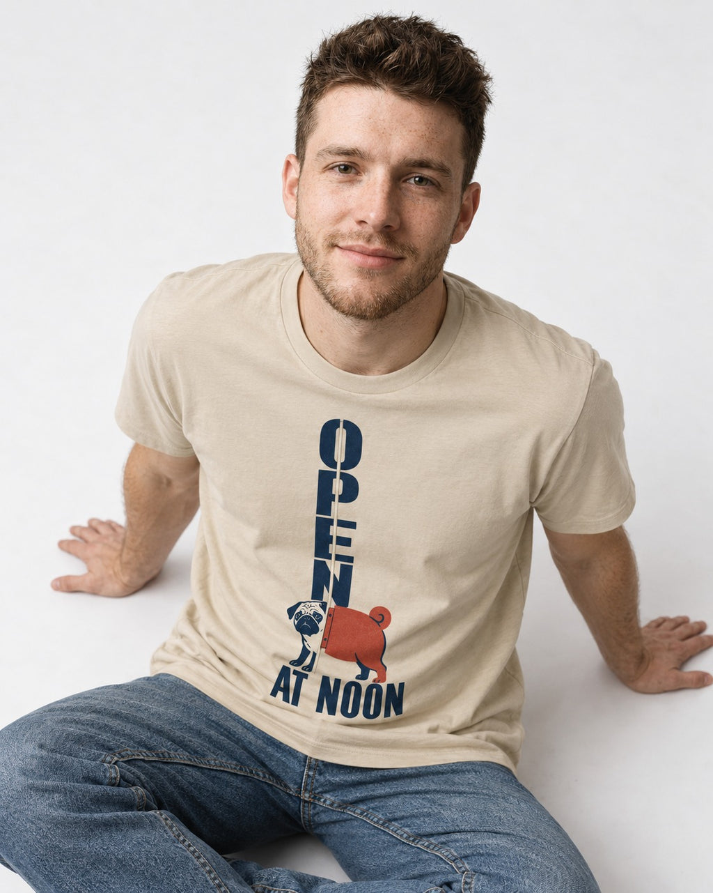 Pug Open at Noon T-Shirt in Sand, worn by a seated model