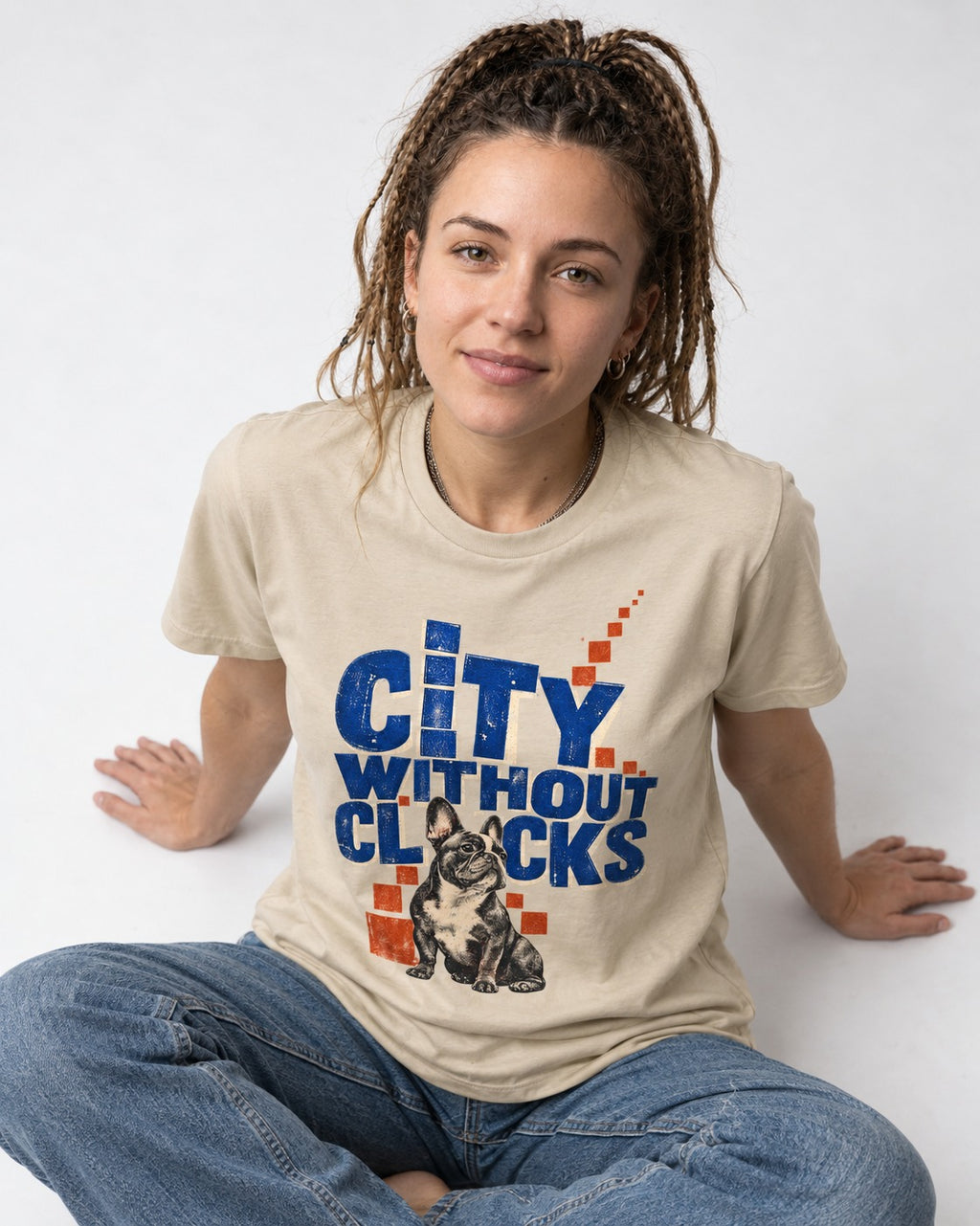 Frenchie's City Without Clocks T-Shirt in Sand, worn by a seated model
