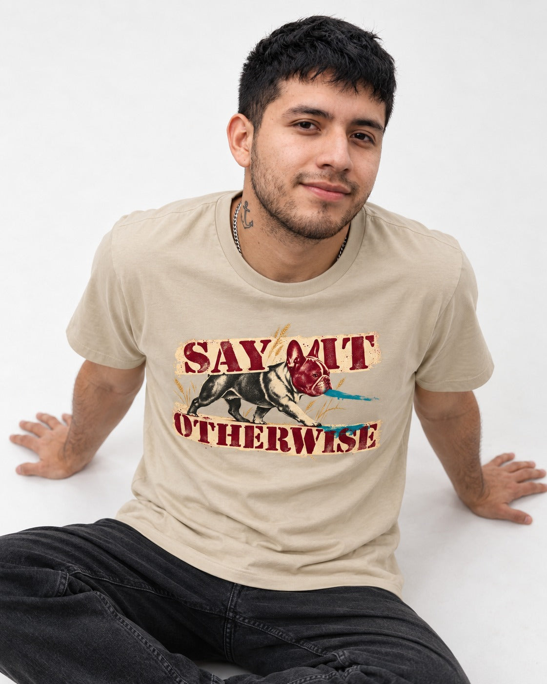 Say It Otherwise Frenchie T-Shirt in Sand, worn by a seated model