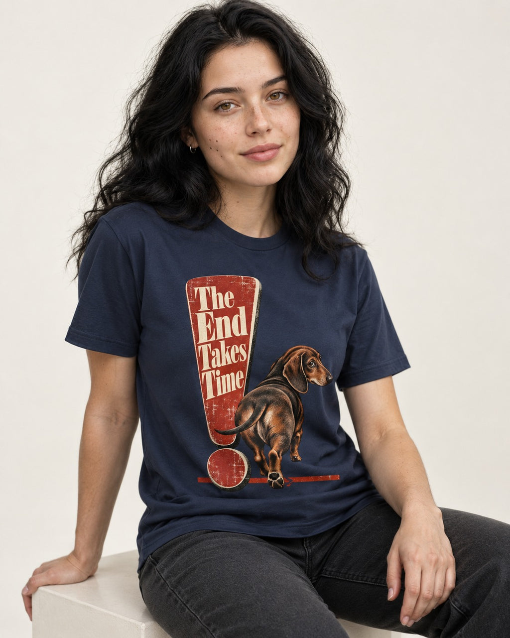 Dachshund The End Takes Time Exclamation Mark Graphic T-Shirt in Navy, worn by a seated model