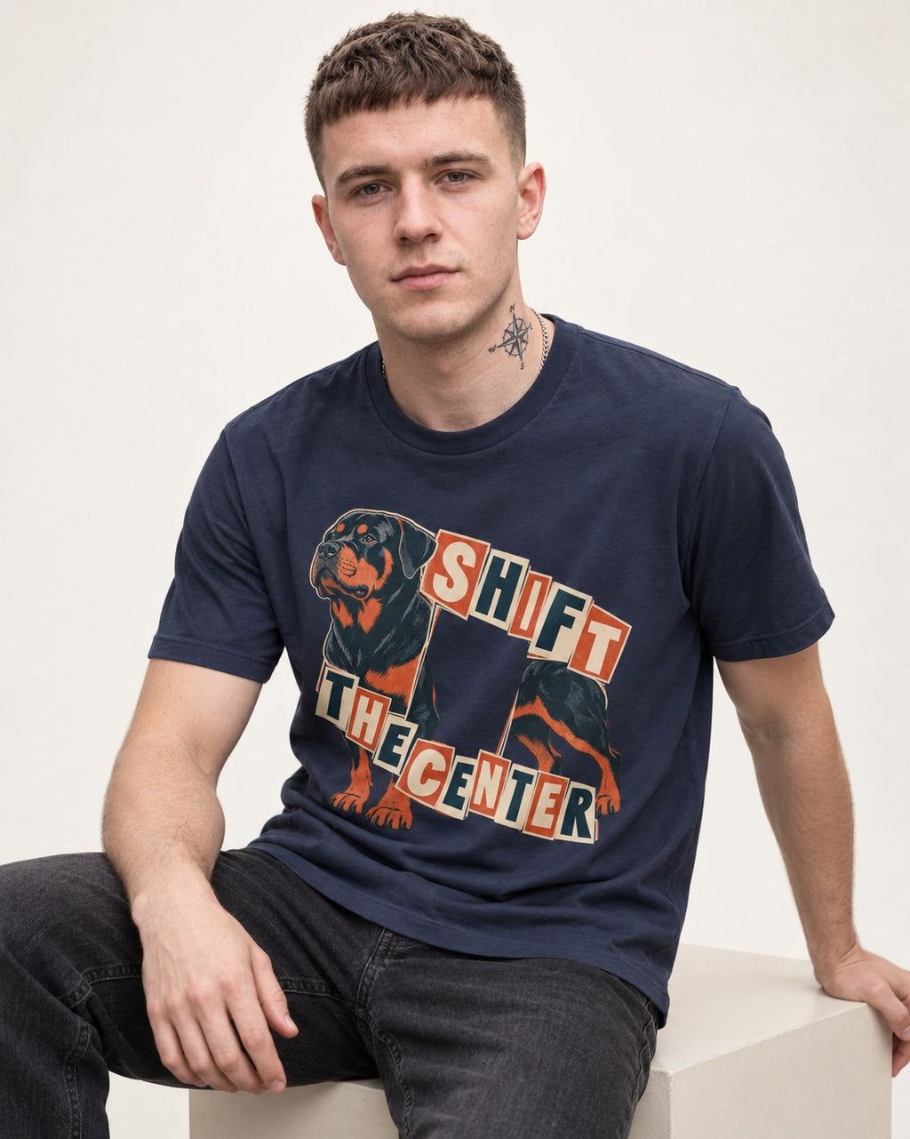 Rottweiler Shift the Center Cutout Letter Graphic T-Shirt in Navy, worn by a seated model