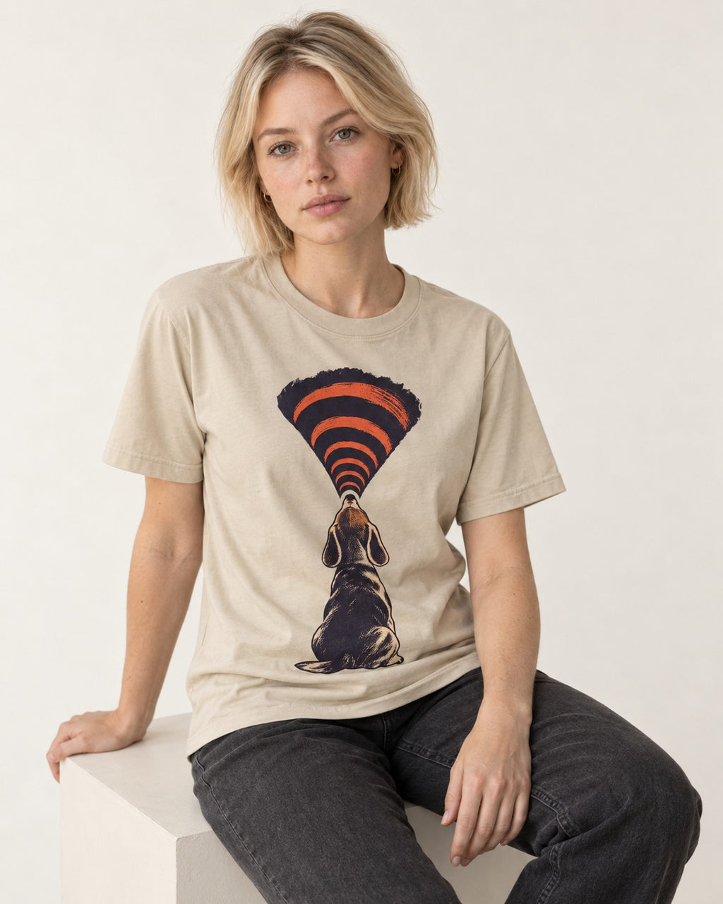 Beagle Broadcast T-Shirt in Sand, worn by a seated model