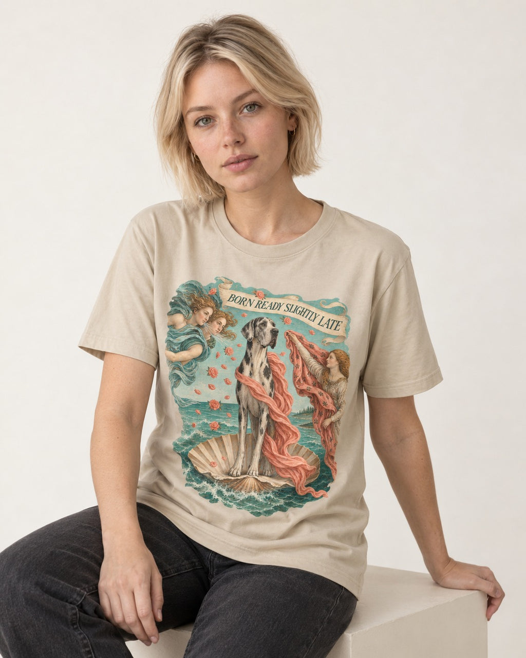 Great Dane Born Ready Slightly Late T-Shirt in Sand, worn by a seated model