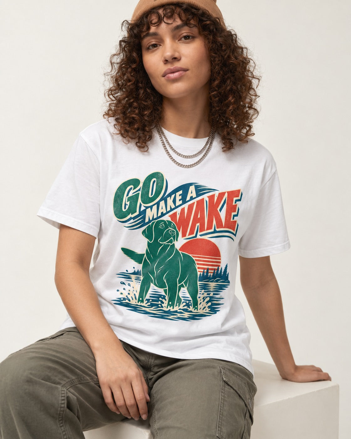Labrador Retriever Go Make a Wake Lake Graphic T-Shirt in White, worn by a seated model
