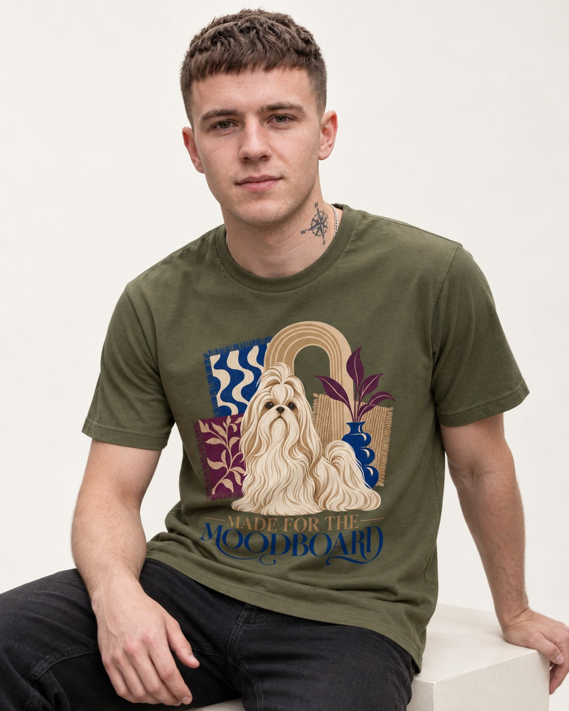 Shih Tzu Made for the Moodboard Boho Interior Graphic T-Shirt in Heather Military Green, worn by a seated model