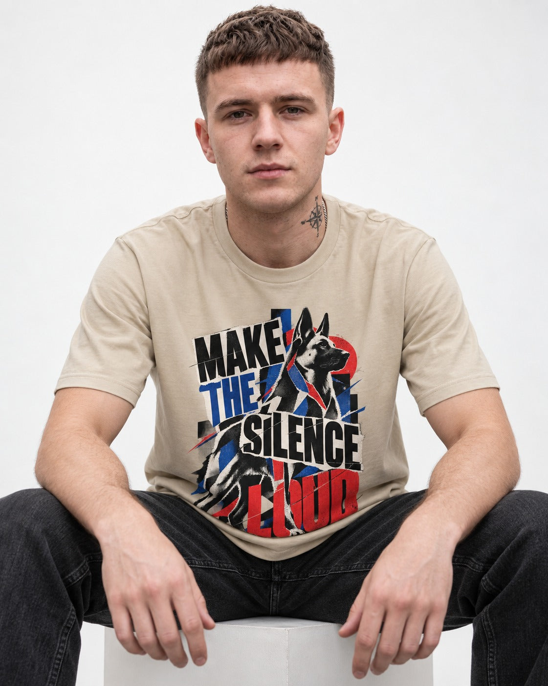 German Shepherd Dog Make the Silence Loud T-Shirt in Sand, worn by a seated model