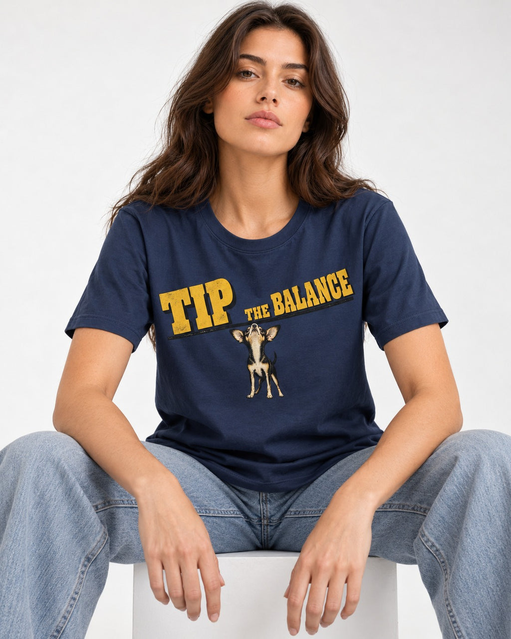 Chihuahua Tip the Balance Beam Graphic T-Shirt in Navy, worn by a seated model