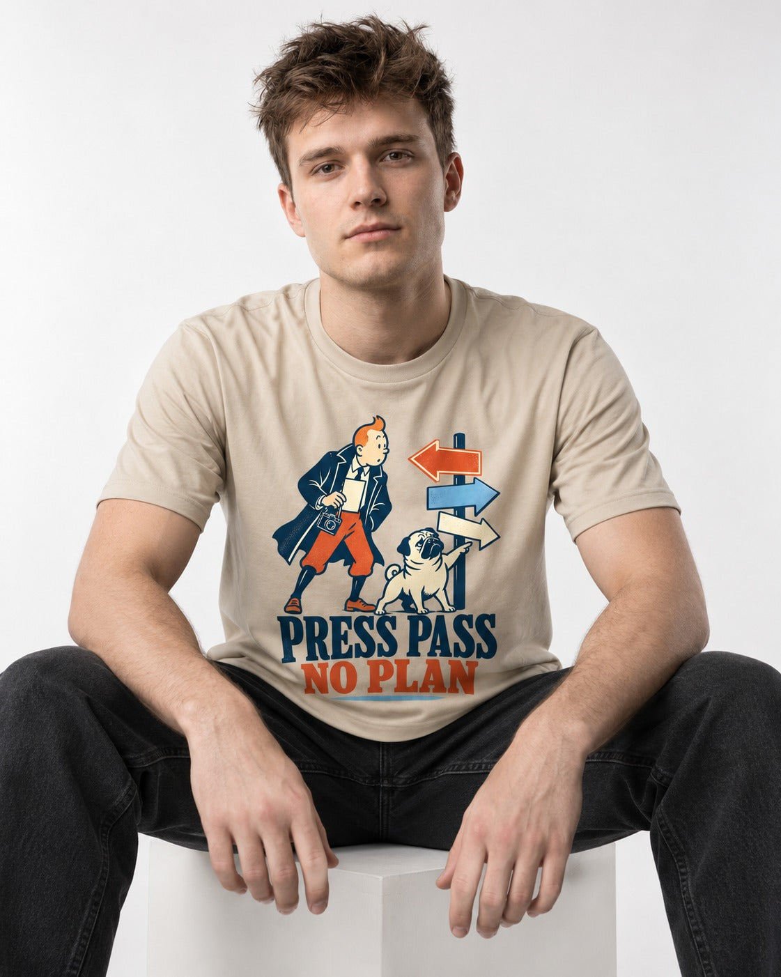 Pug Press Pass No Plan T-Shirt in Sand, worn by a seated model