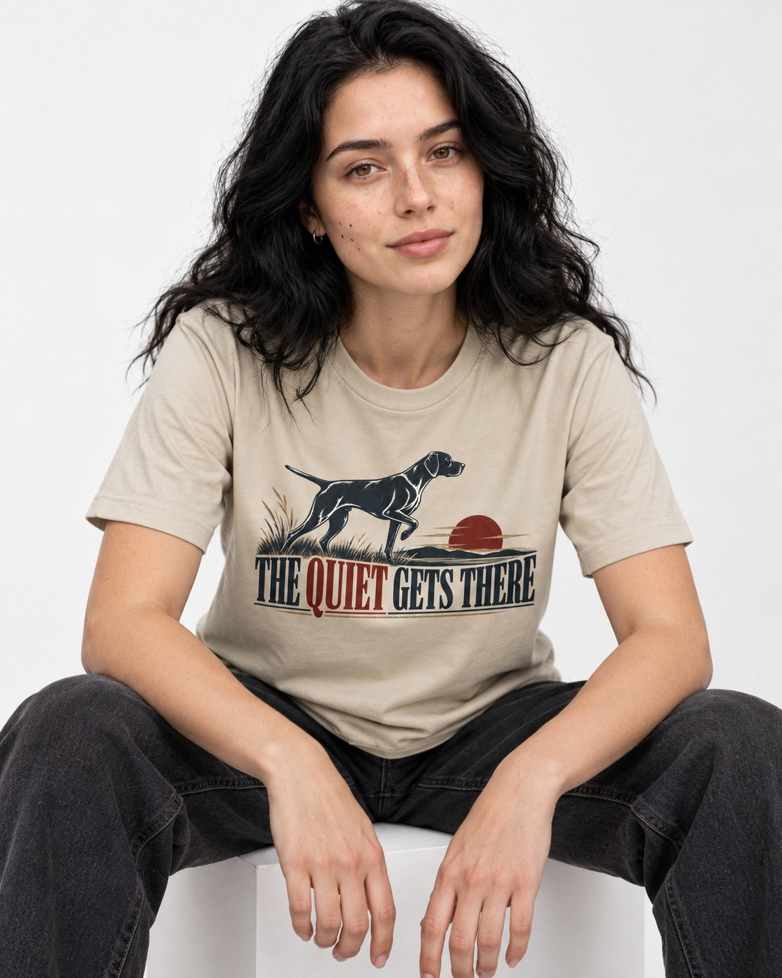 The Quiet Gets There German Shorthaired Pointer T-Shirt in Sand, worn by a seated model