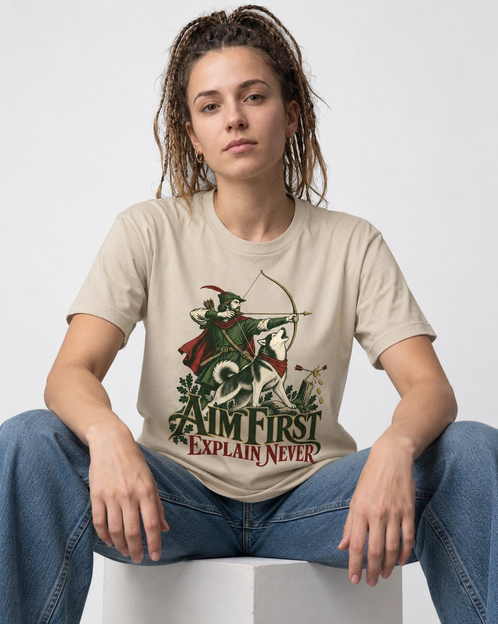 Husky Aim First Explain Never T-Shirt in Sand, worn by a seated model