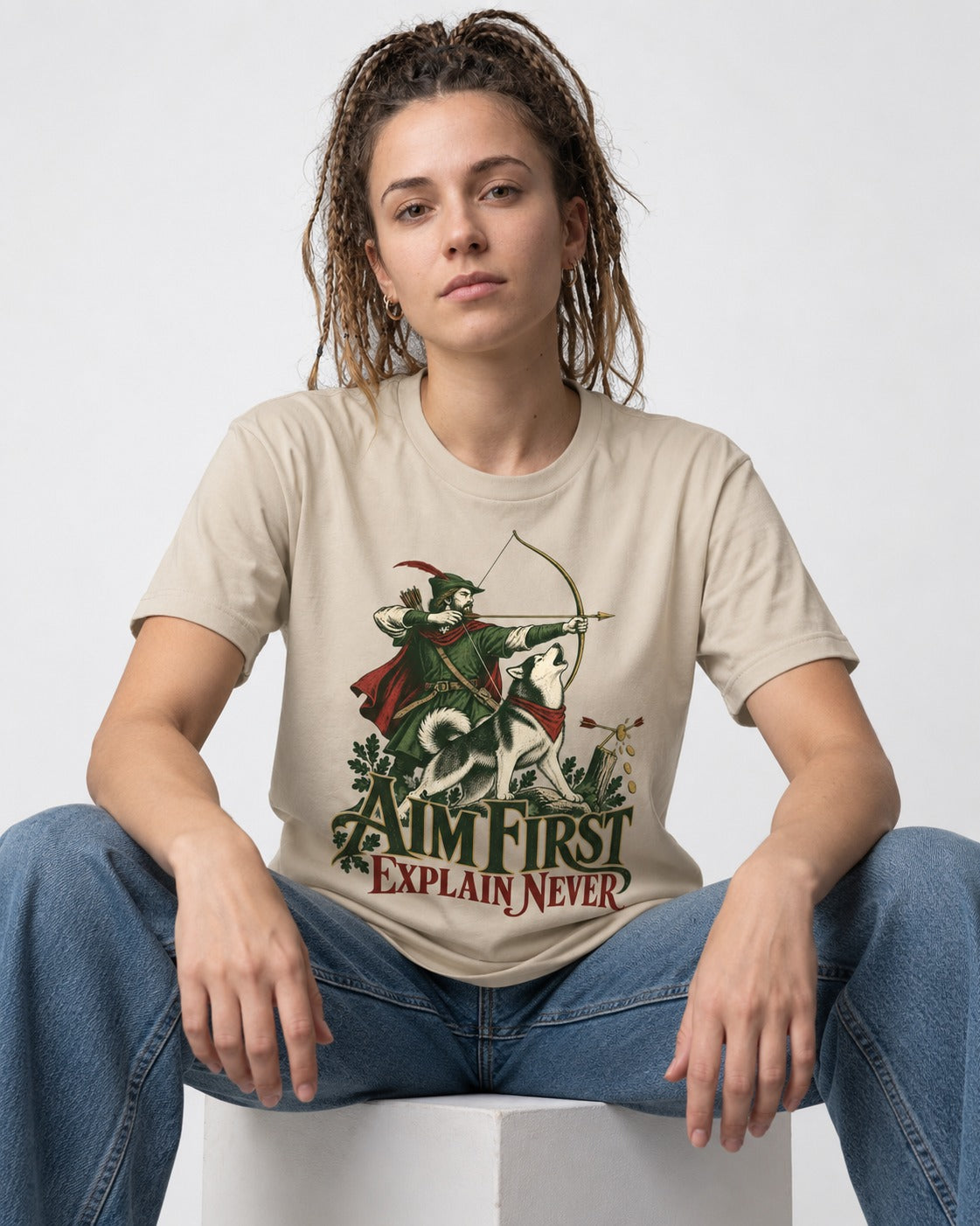 Husky Aim First Explain Never T-Shirt in Sand, worn by a seated model