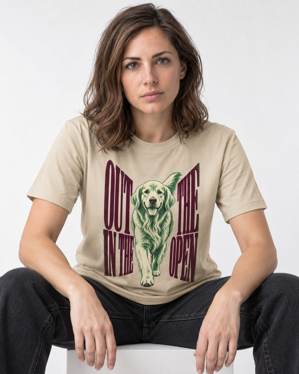 Golden Retriever Out in the Open T-Shirt in Sand, worn by a seated model