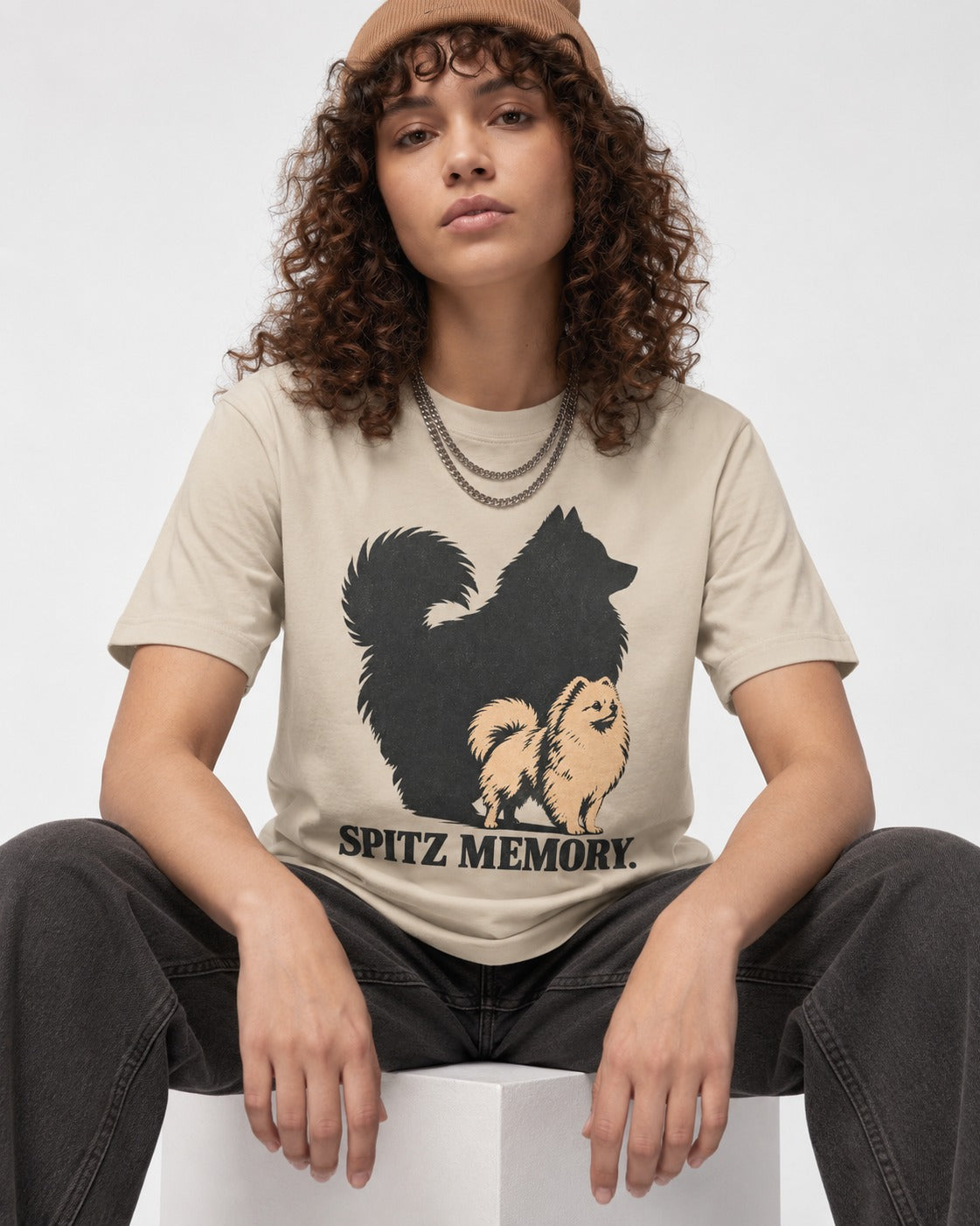 Pomeranian Spitz Memory T-Shirt in Sand, worn by a seated model