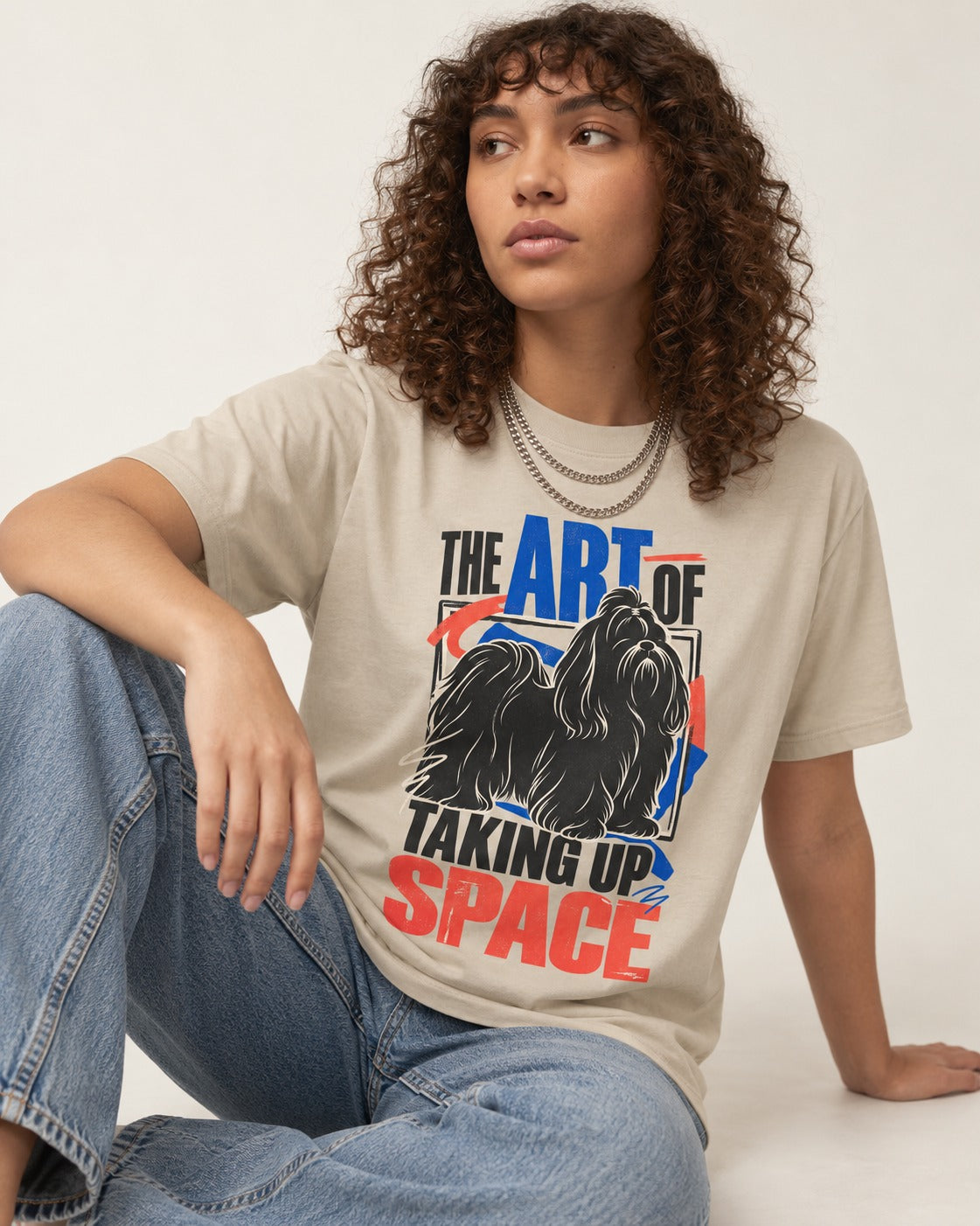 Shih Tzu Taking Up Space T-Shirt in Sand, worn by a seated model