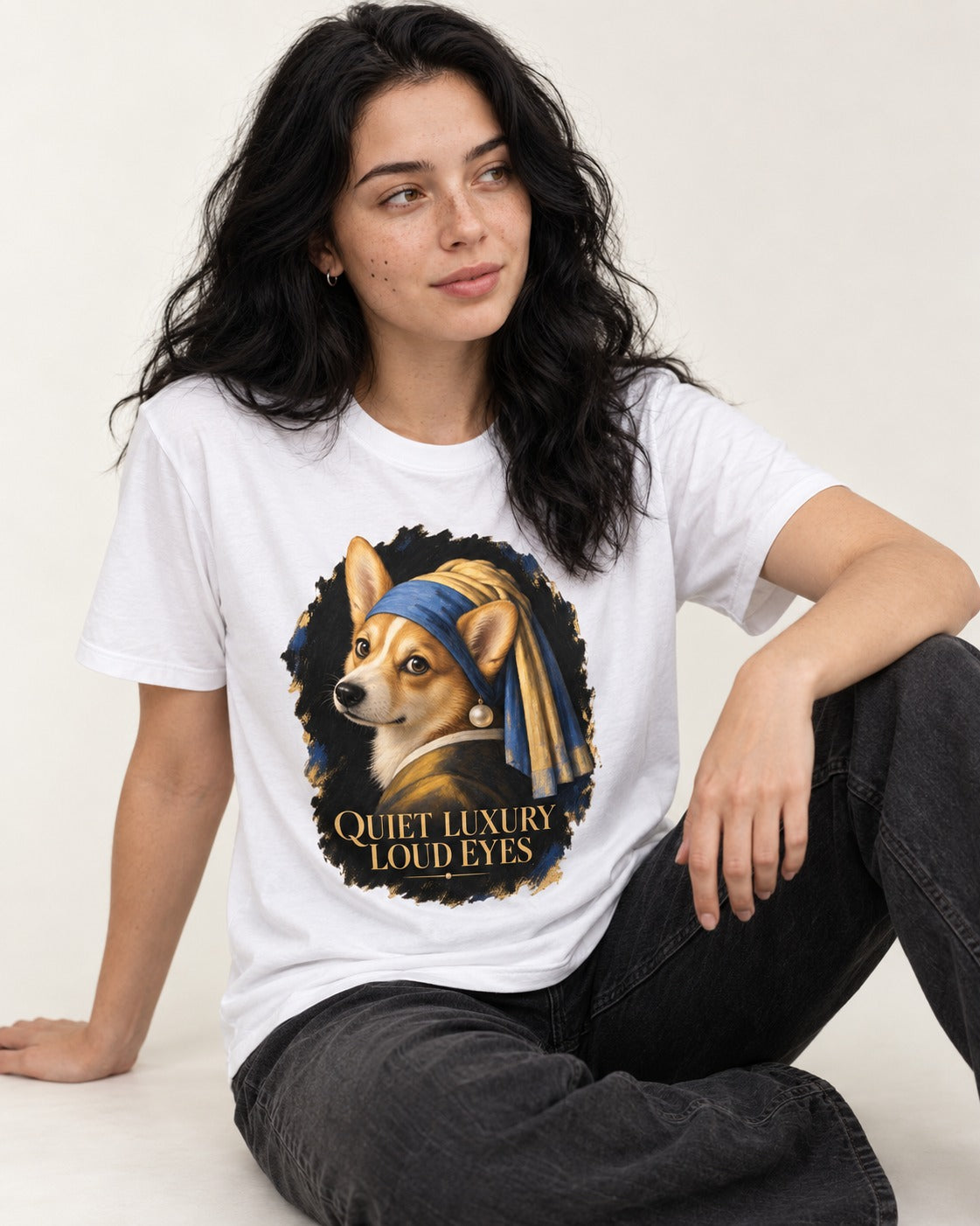 Corgi Quiet Luxury Loud Eyes Pearl Earring Portrait T-Shirt in White, worn by a seated model