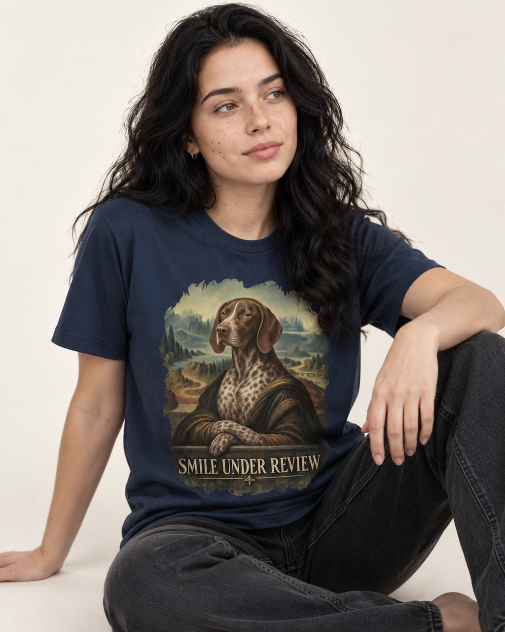 German Shorthaired Pointer Smile Under Review Renaissance Portrait Graphic T-Shirt in Navy, worn by a seated model