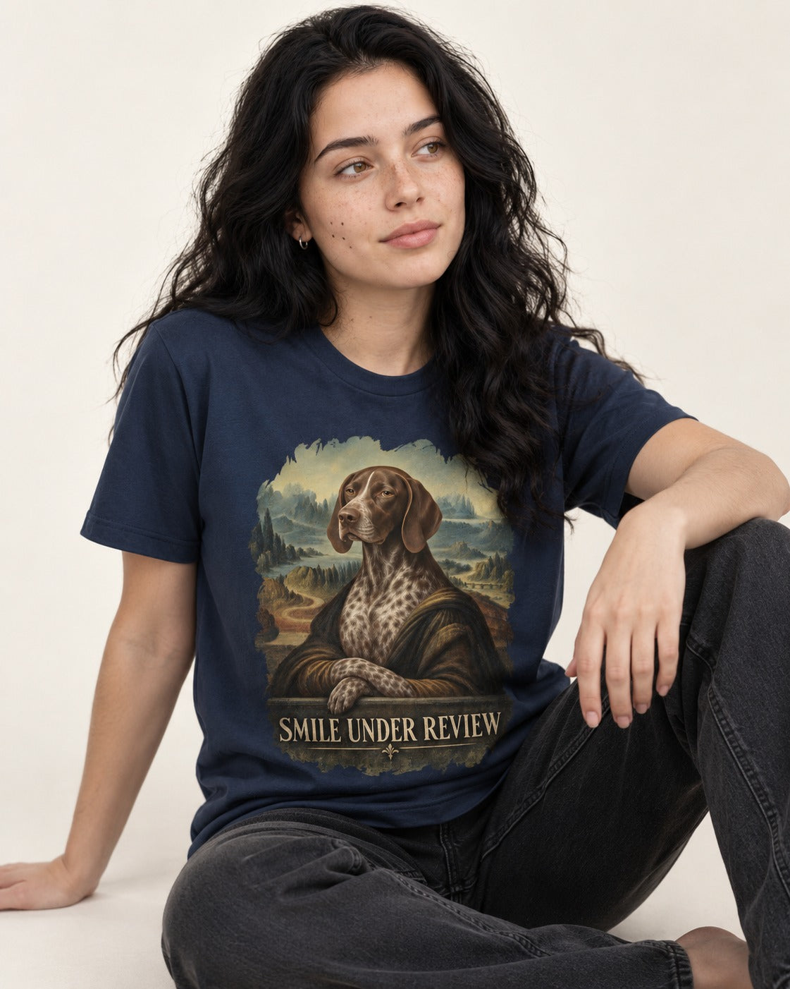German Shorthaired Pointer Smile Under Review Renaissance Portrait Graphic T-Shirt in Navy, worn by a seated model