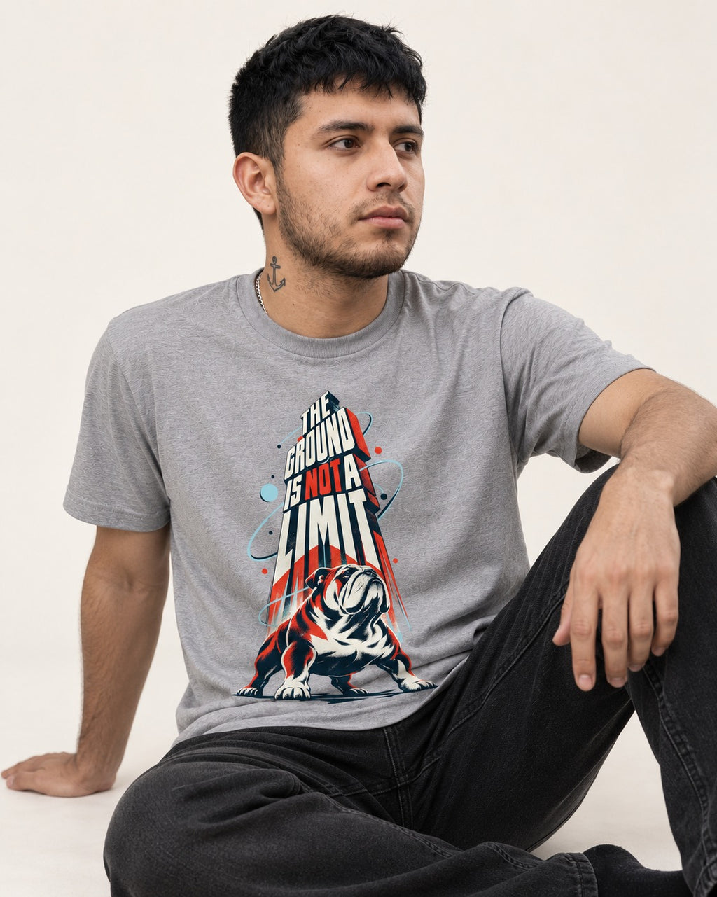 English Bulldog The Ground Is Not a Limit Orbital Graphic T-Shirt in Sport Grey, worn by a seated model
