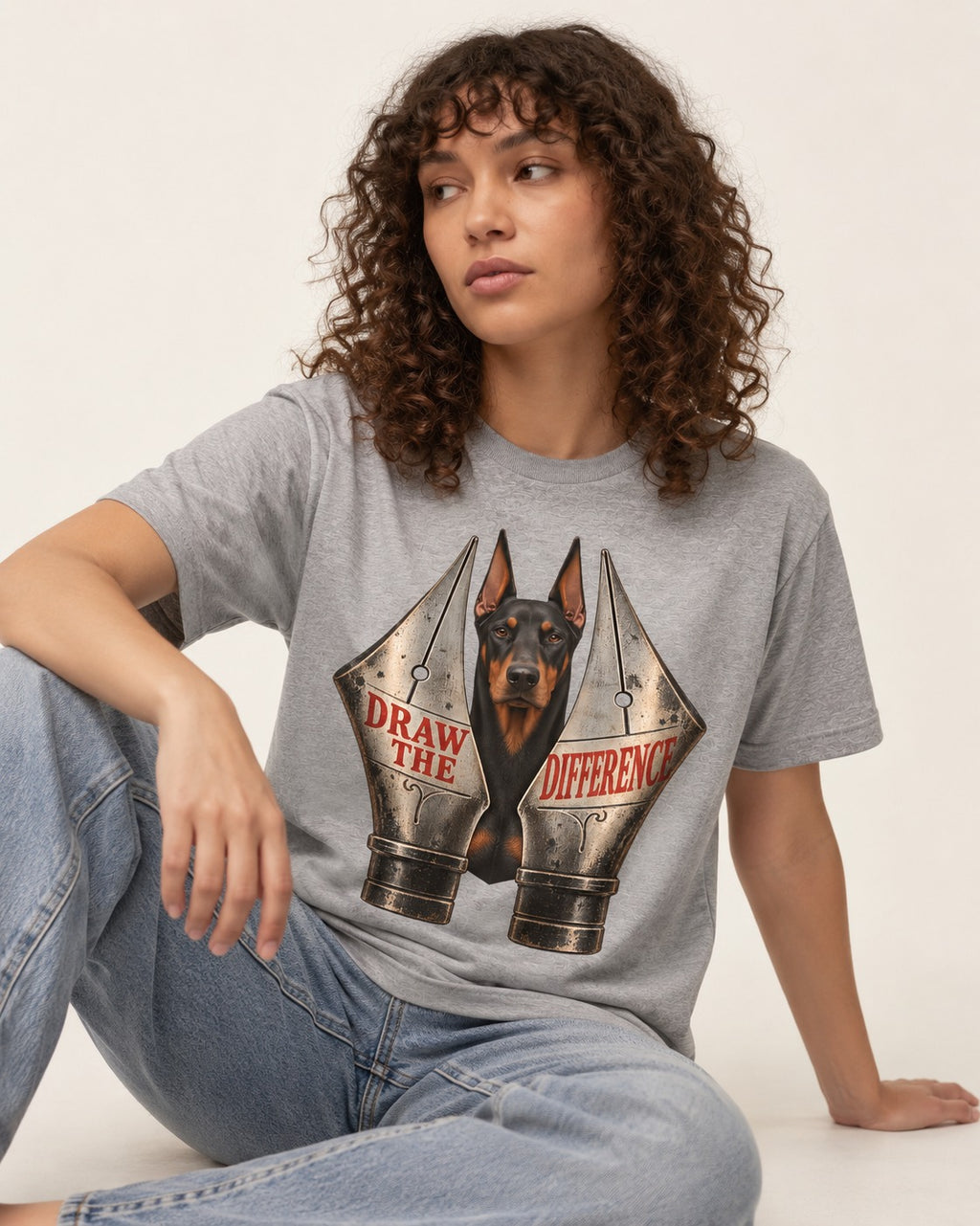 Doberman Draw the Difference T-Shirt in Sport Grey, worn by a seated model