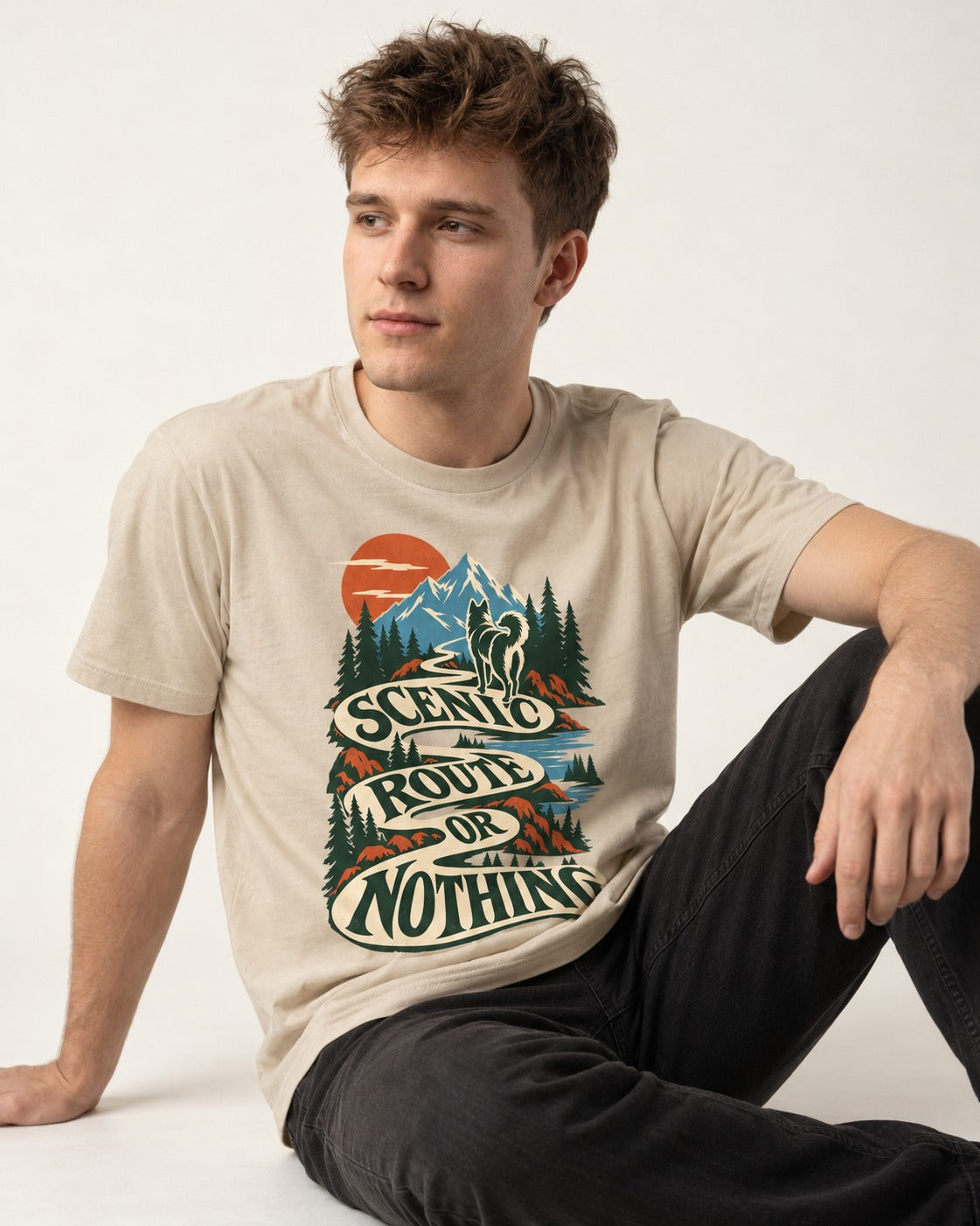 Husky Scenic Route or Nothing T-Shirt in Sand, worn by a seated model