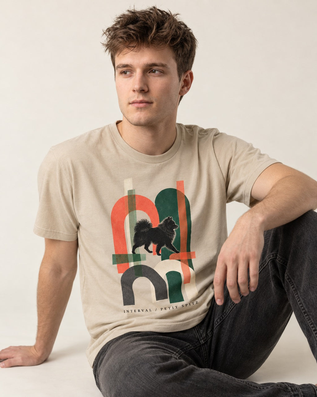 Pomeranian Interval T-Shirt in Sand, worn by a seated model