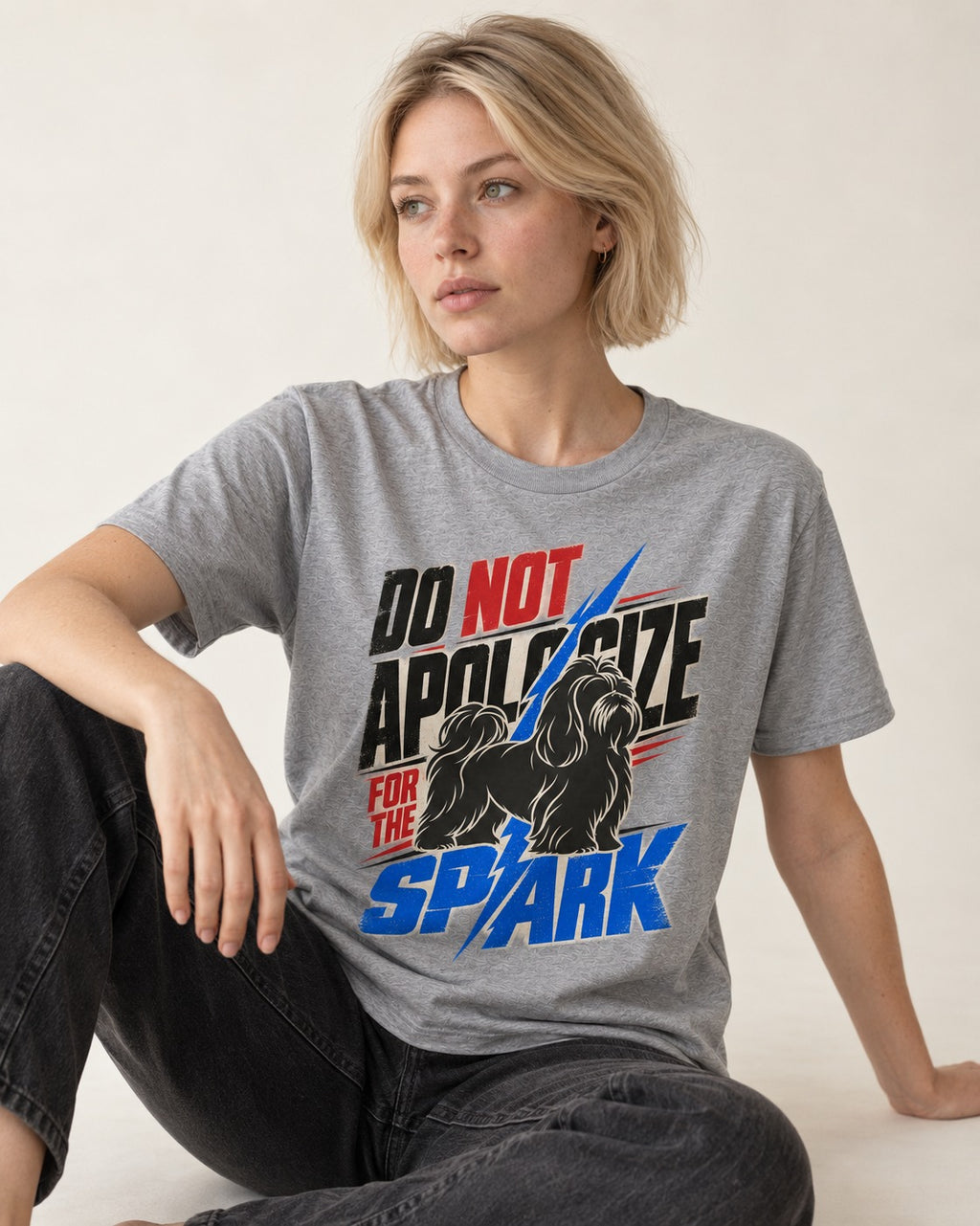Never Apologize for Shih Tzu Spark T-Shirt in Sport Grey, worn by a seated model