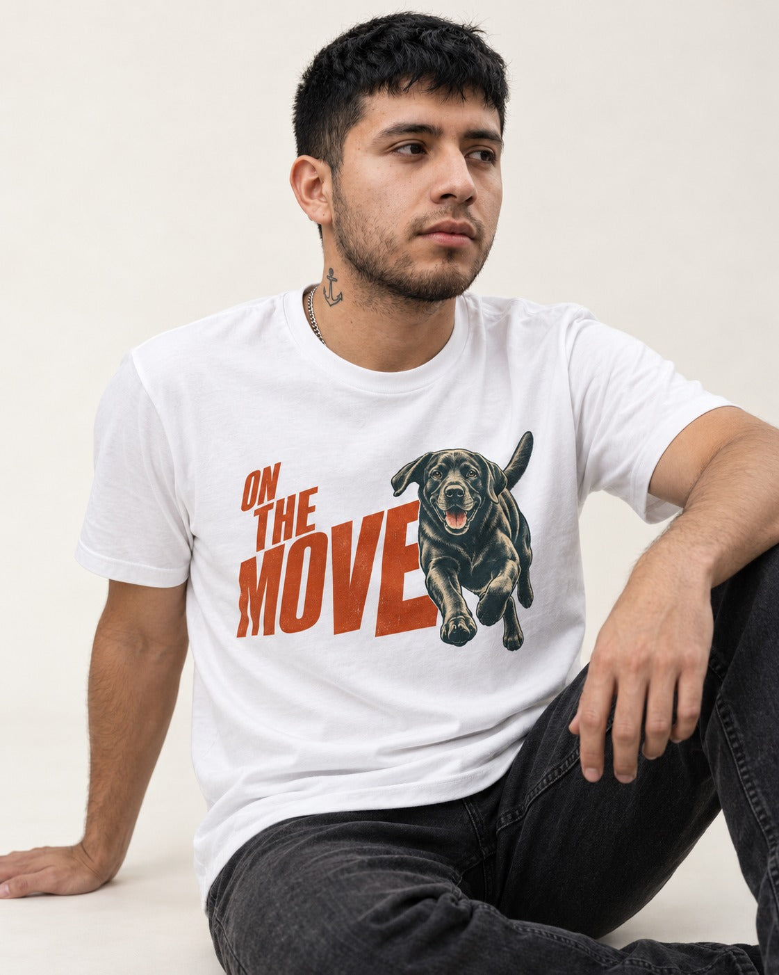 Labrador Retriever On the Move Running Graphic T-Shirt in White, worn by a seated model