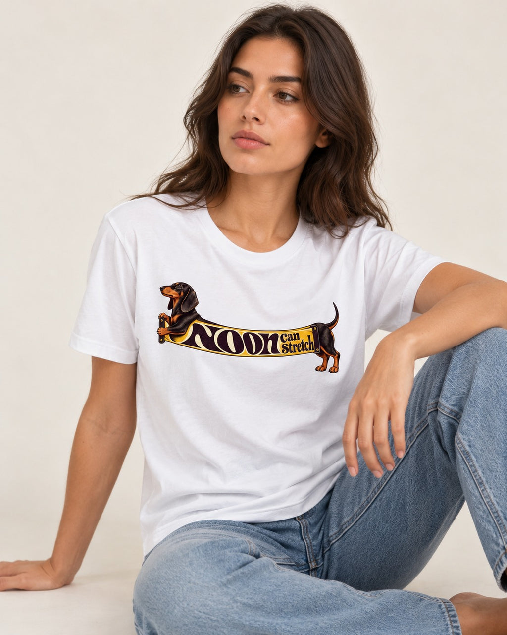 Dachshund Noon Can Stretch Sign Graphic T-Shirt in White, worn by a seated model