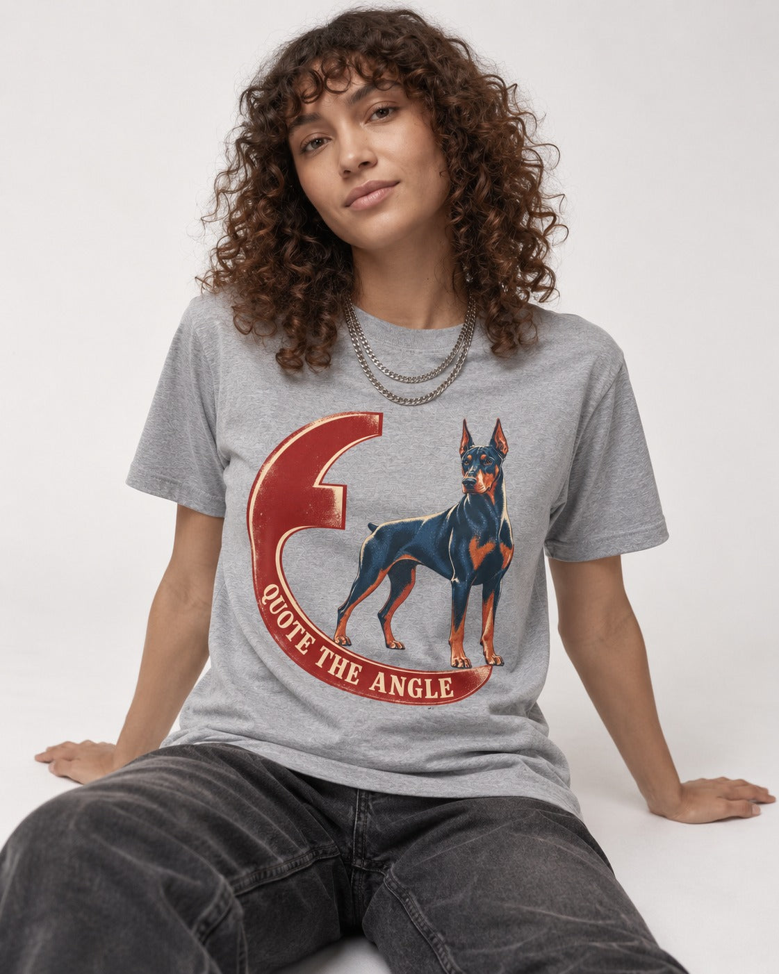 Doberman Quote the Angle Crescent Graphic T-Shirt in Sport Grey, worn by a seated model