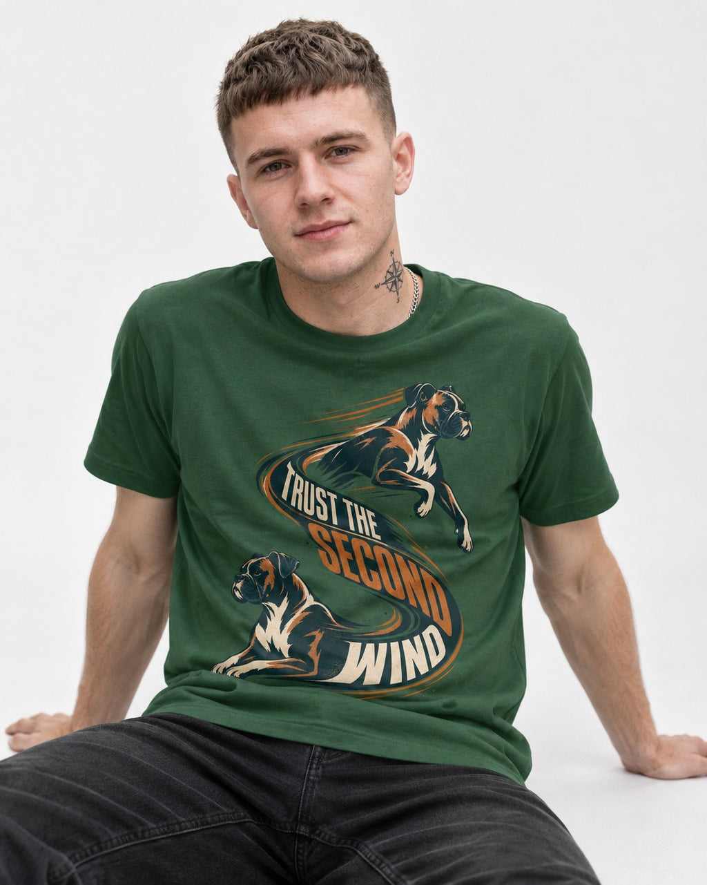 Trust the Second Wind Boxer Motion Graphic T-Shirt in Forest Green, worn by a seated model