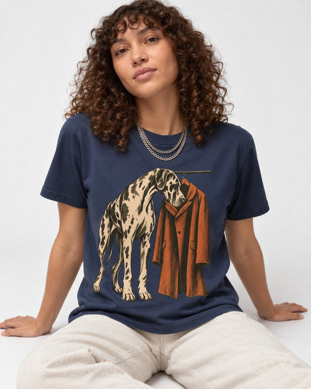 Great Dane Harlequin Coat Rack Overcoat Graphic T-Shirt in Navy, worn by a seated model