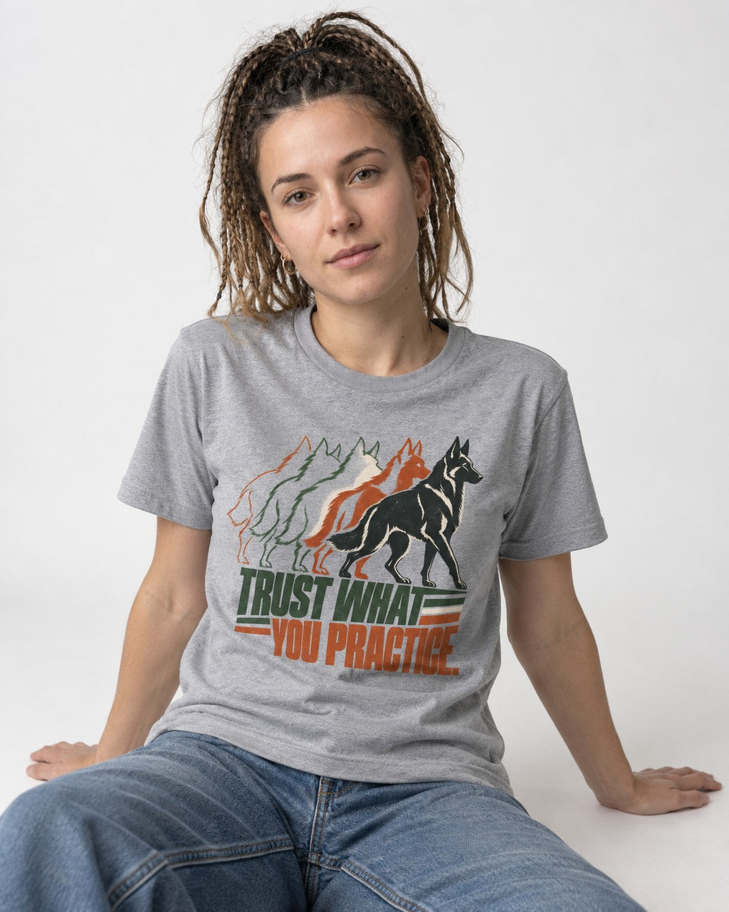 Trust What You Practice German Shepherd Dog T-Shirt in Sport Grey, worn by a seated model