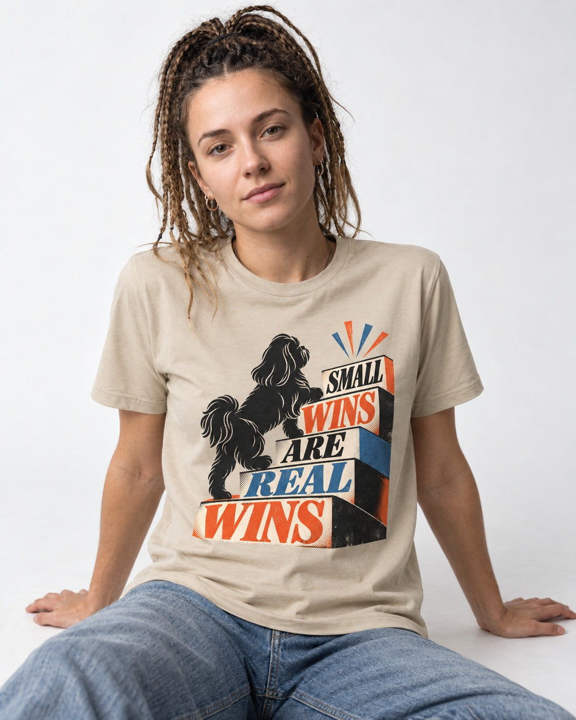 Small Wins Shih Tzu T-Shirt in Sand, worn by a seated model