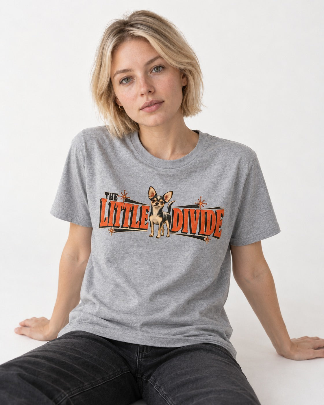 Chihuahua The Little Divide Retro Sign Graphic T-Shirt in Sport Grey, worn by a seated model