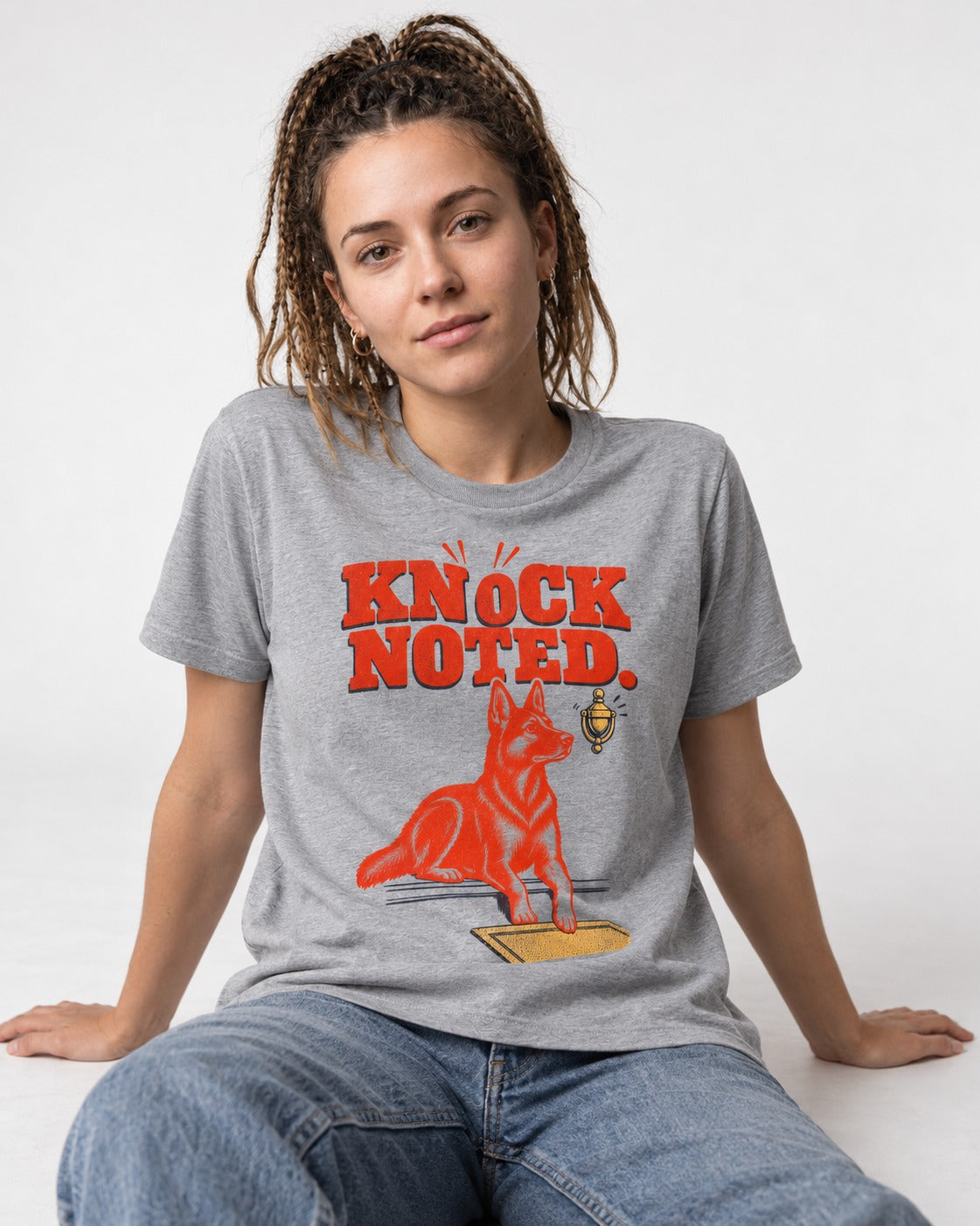 Knock Noted Door Knocker German Shepherd Dog Graphic T-Shirt in Sport Grey, worn by a seated model