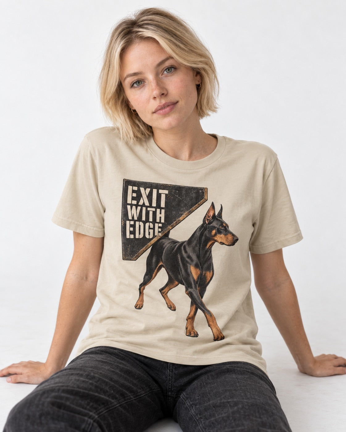 Exit with Doberman Edge T-Shirt in Sand, worn by a seated model